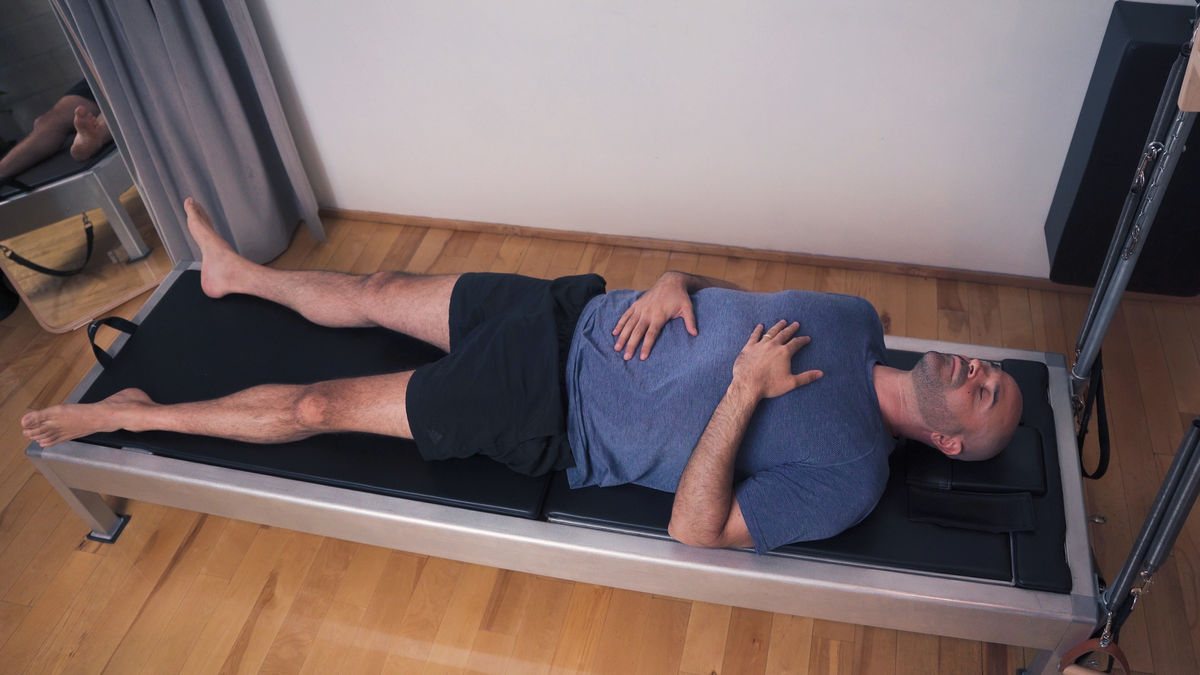 A person practicing a calming post Pilates meditation in a peaceful setting, promoting relaxation and better sleep.