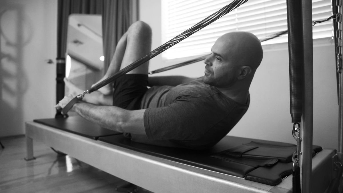 A person practicing Pilates with a serene expression, emphasizing mental clarity and focus.