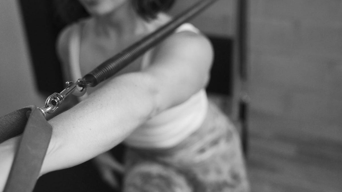 Unlock your body's potential at our Pilates studio in Los Angeles, woman performing a challenging Contrology tower routine.