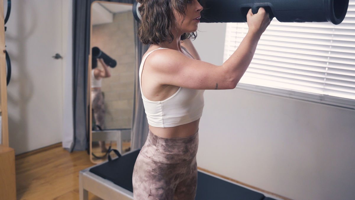 Enhancing functional movement: a centered woman skillfully incorporating a Vipr into her Physical Therapy and Pilates routine while at our private West Hollywood Pilates studio.