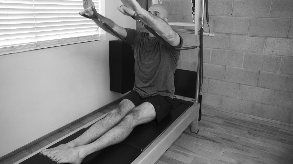 A busy professional maximizing time with an efficient Pilates session at West Hollywood Pilates.